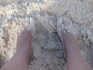 V's feet in Bahama sand